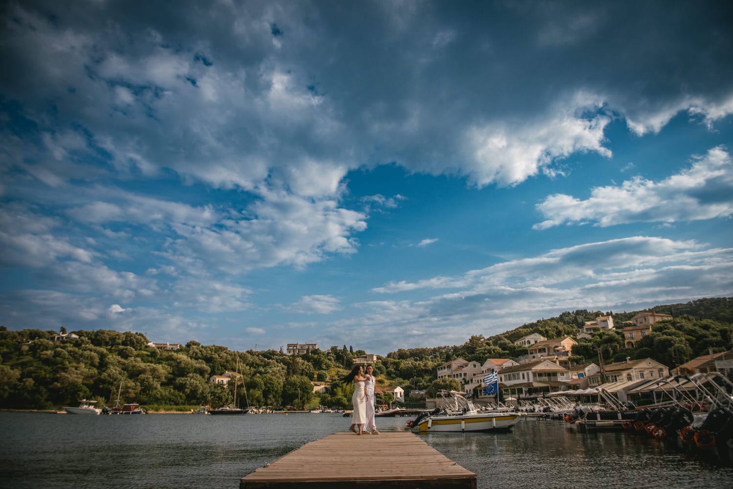 Seaside harmony: Brides walk along the shore, love's rhythm echoed in the waves during their Corfu elopement.