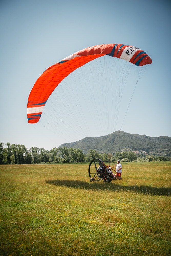 Bride enjoying the thrilling paragliding experience, embracing the beauty of Corfu.
