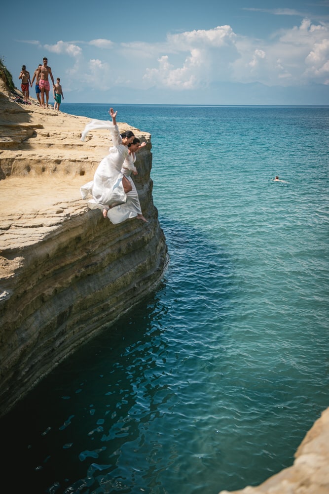 Brides leaping into the water, relishing the joy of their Corfu elopement.