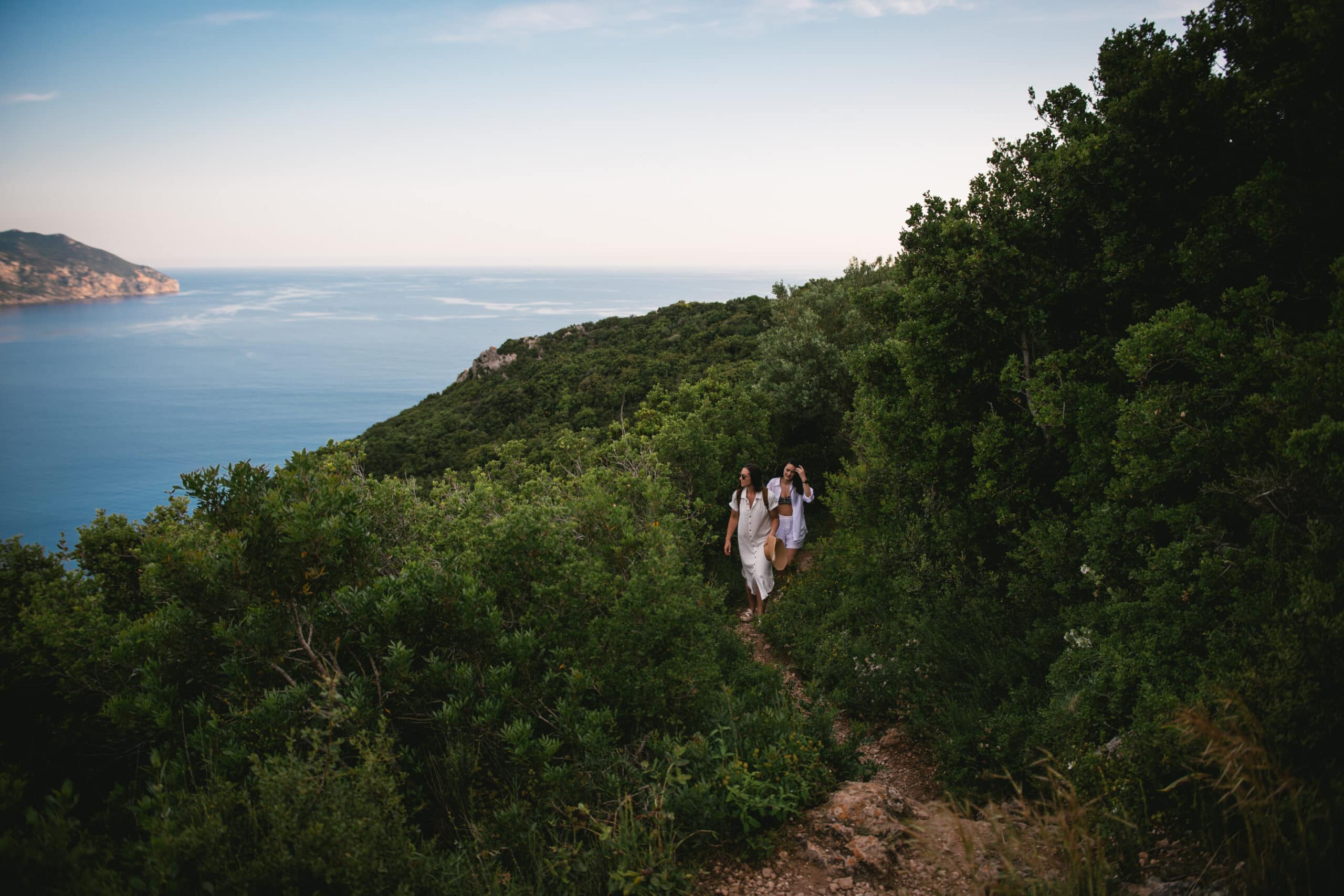 Brides walking amidst the lush bushes, immersing themselves in the natural surroundings of Corfu.