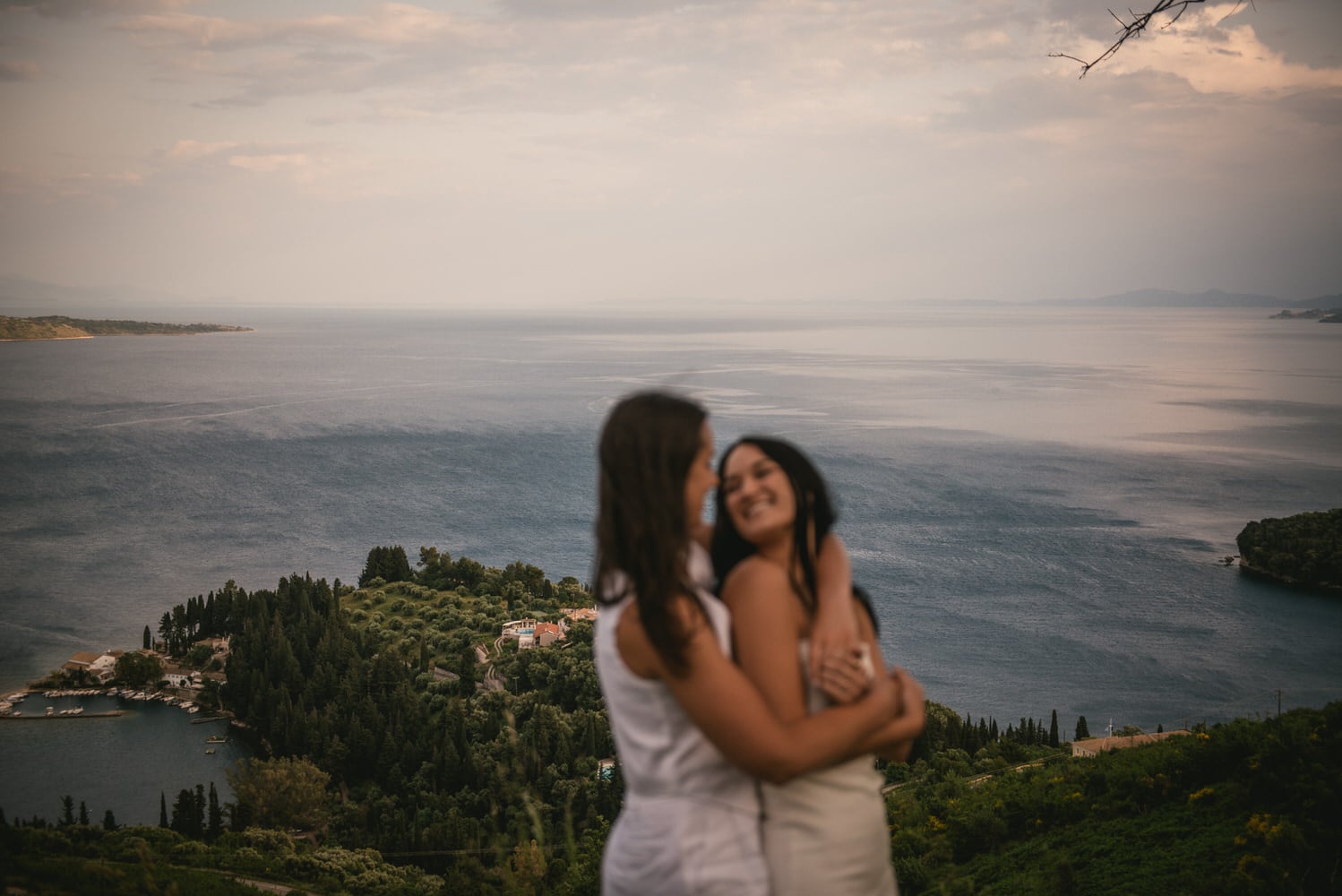 Seaside harmony: Brides walk along the shore, love's rhythm echoed by the waves during their Corfu elopement.
