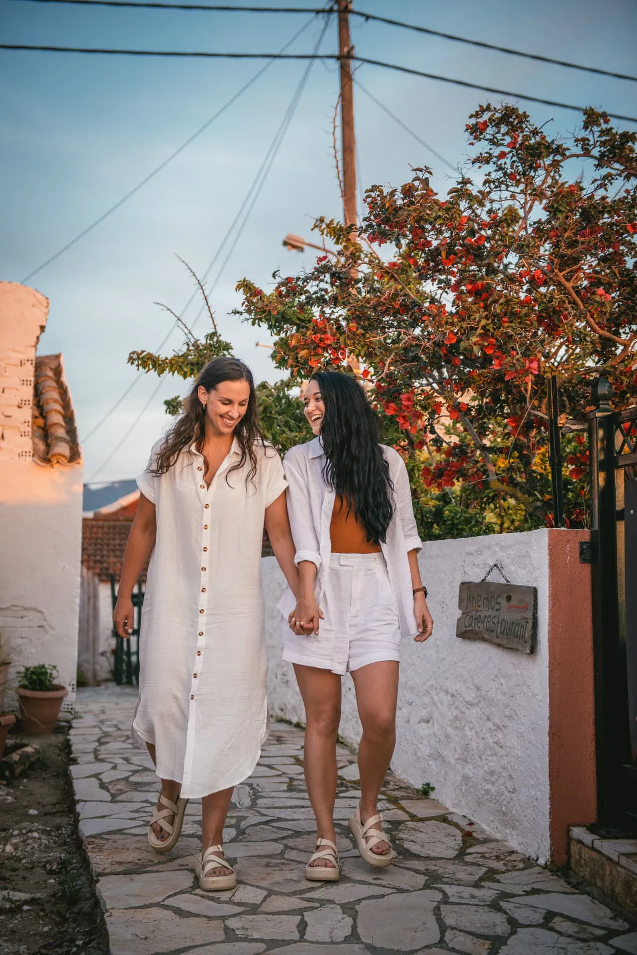 Brides walking hand in hand along the charming streets of Corfu, embracing the local atmosphere.