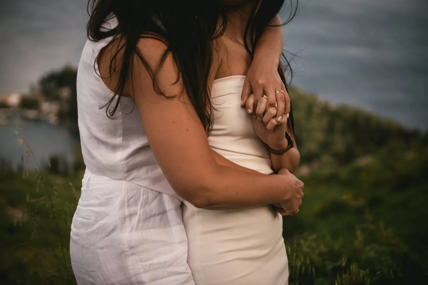 Seaside harmony: Brides walk along the shore, love's rhythm echoed by the waves during their Corfu elopement.
