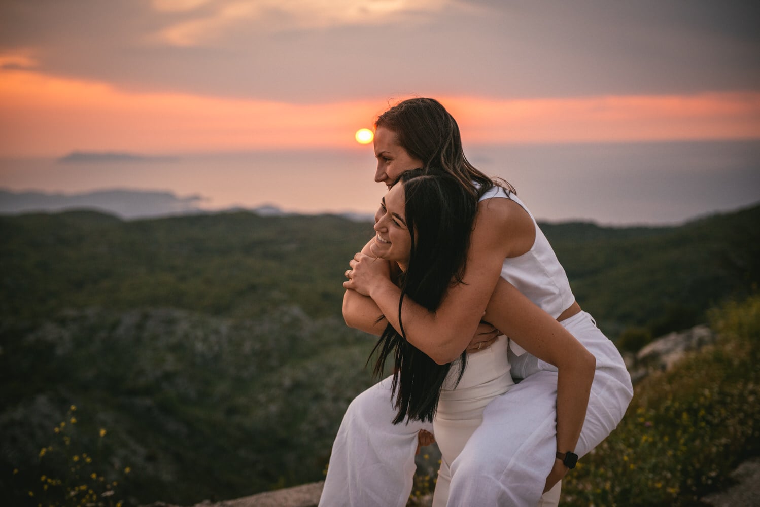 Guided by winding roads: Brides' journey to Mount Pantokrator's summit, love leading the way during their Corfu elopement.