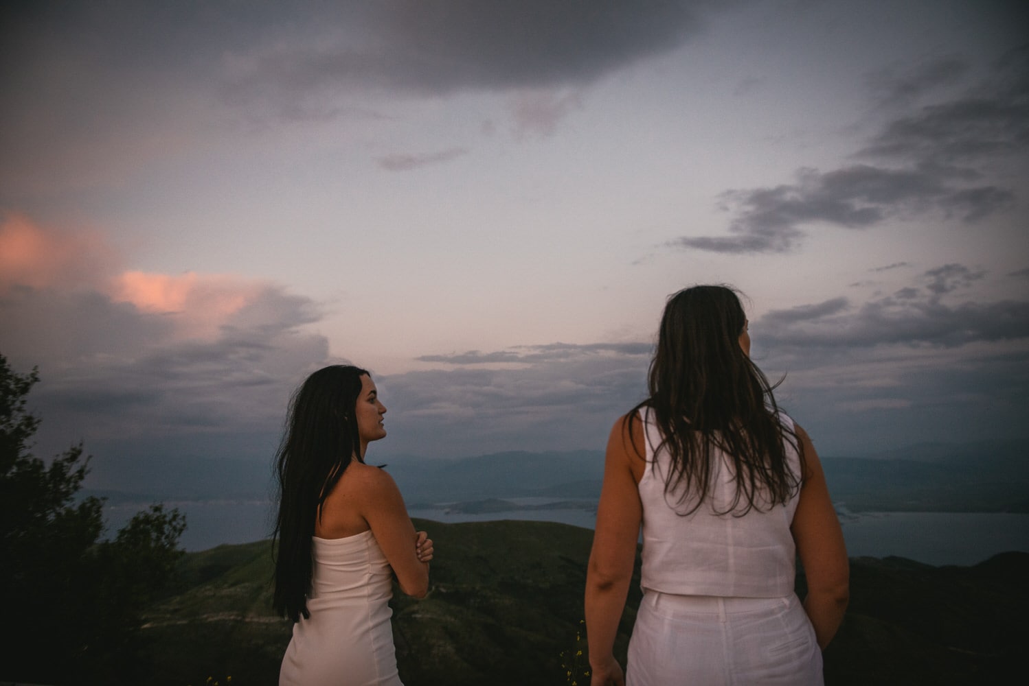 Guided by winding roads: Brides' journey to Mount Pantokrator's summit, love leading the way during their Corfu elopement.