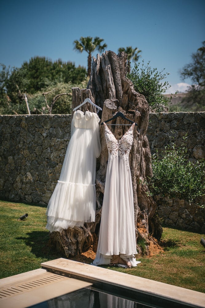 Dresses hung on an olive tree, anticipation in the air for their Corfu elopement.