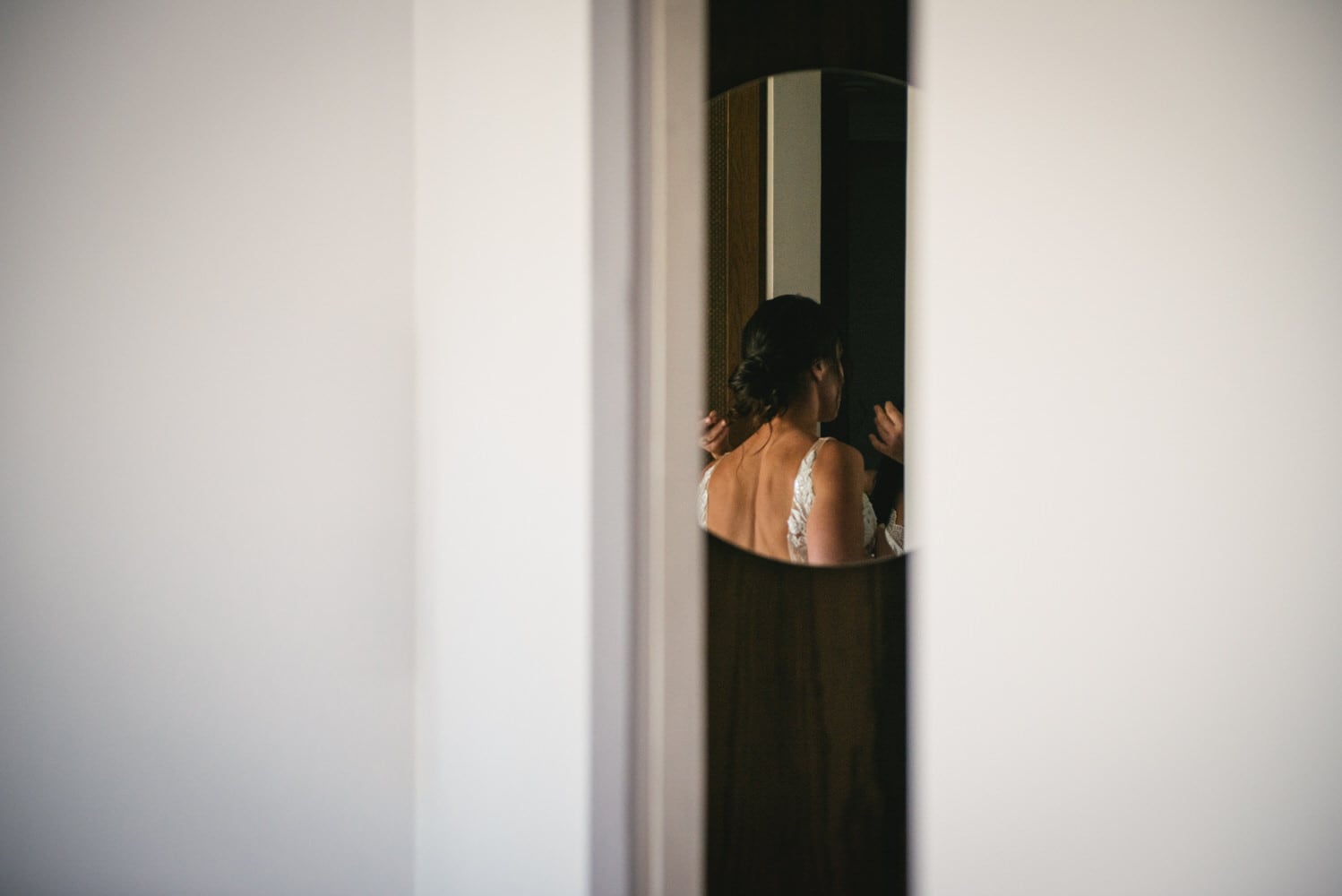 Details of the bride putting on her dress, elegance for their Corfu elopement.