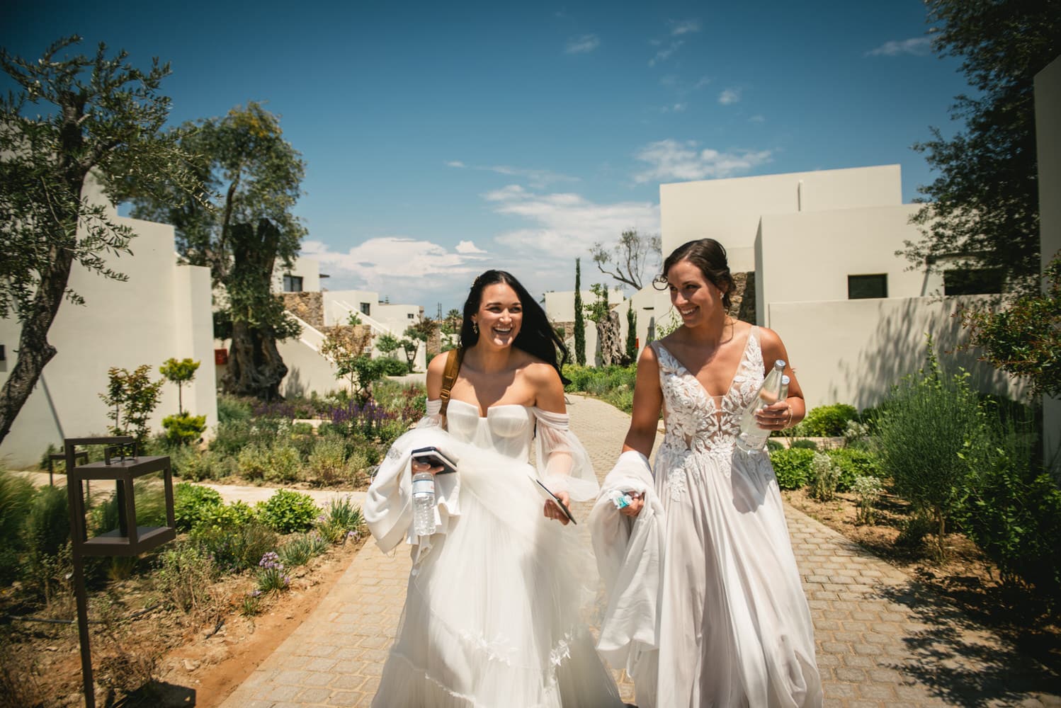 Brides walking outside, laughter echoing on their Corfu elopement day.