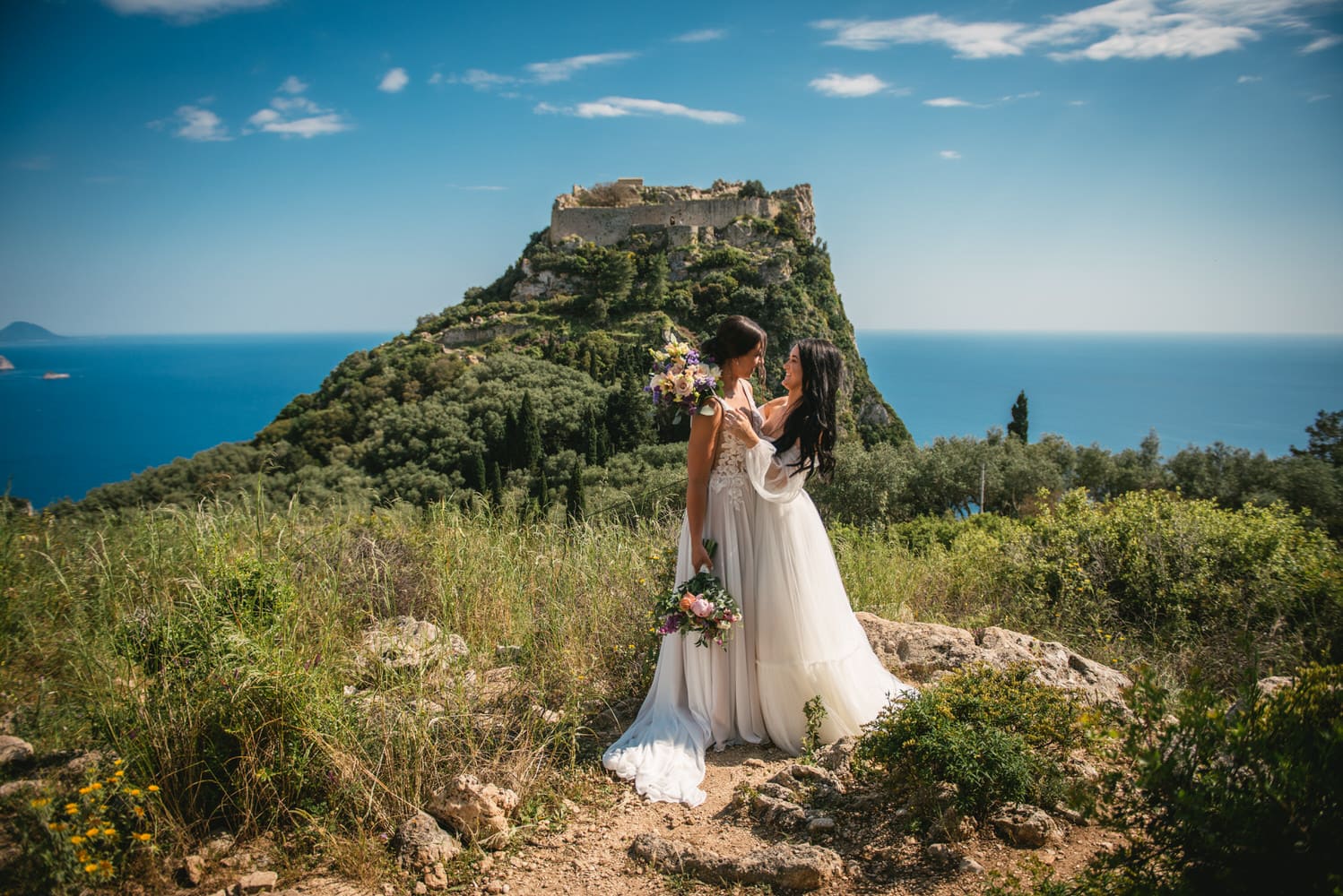 Castles and love stories: Brides stand among ancient ruins, a testament to their Corfu elopement.