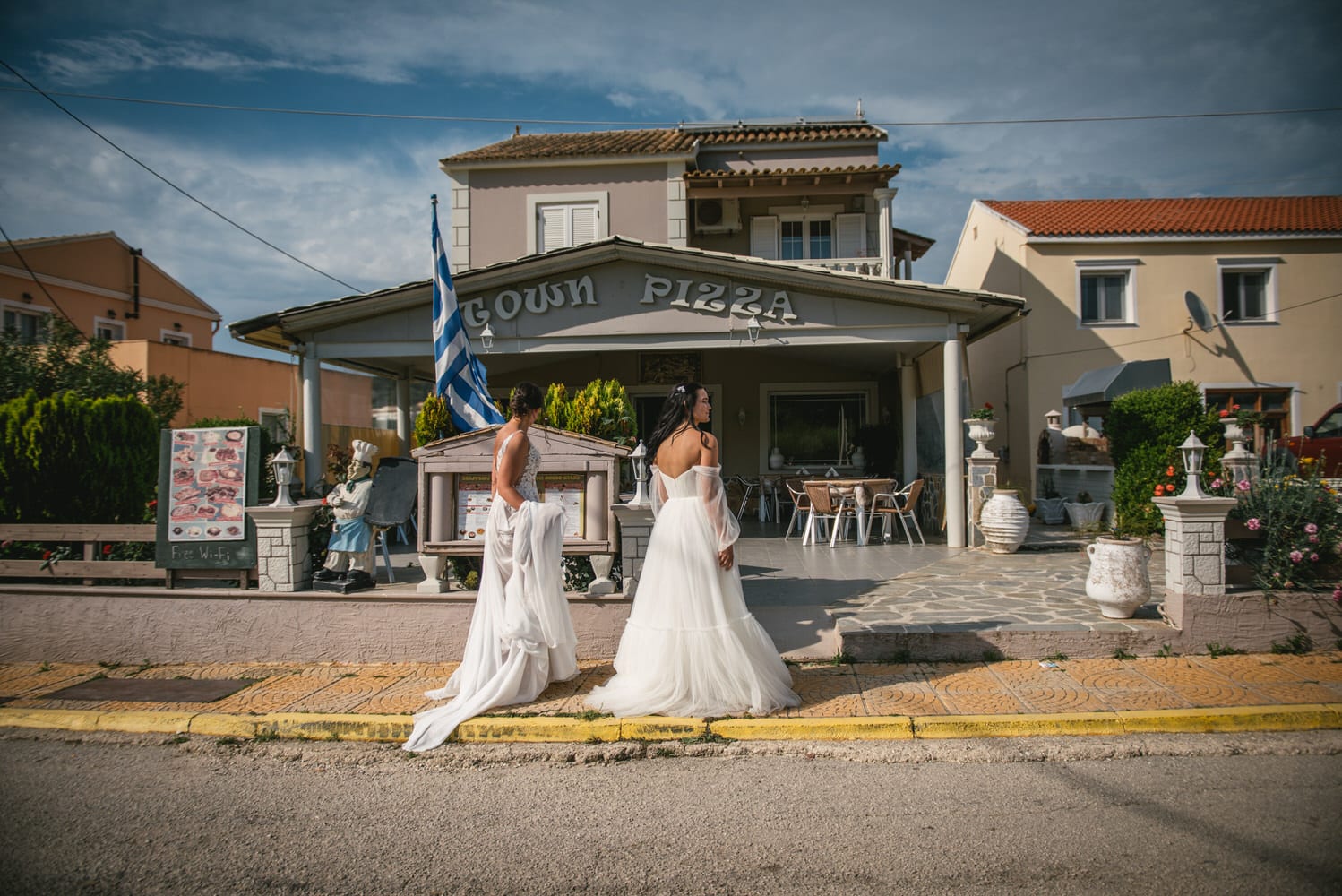 Bridal bouquets in hand, brides explore a flower shop during their Corfu elopement adventure.