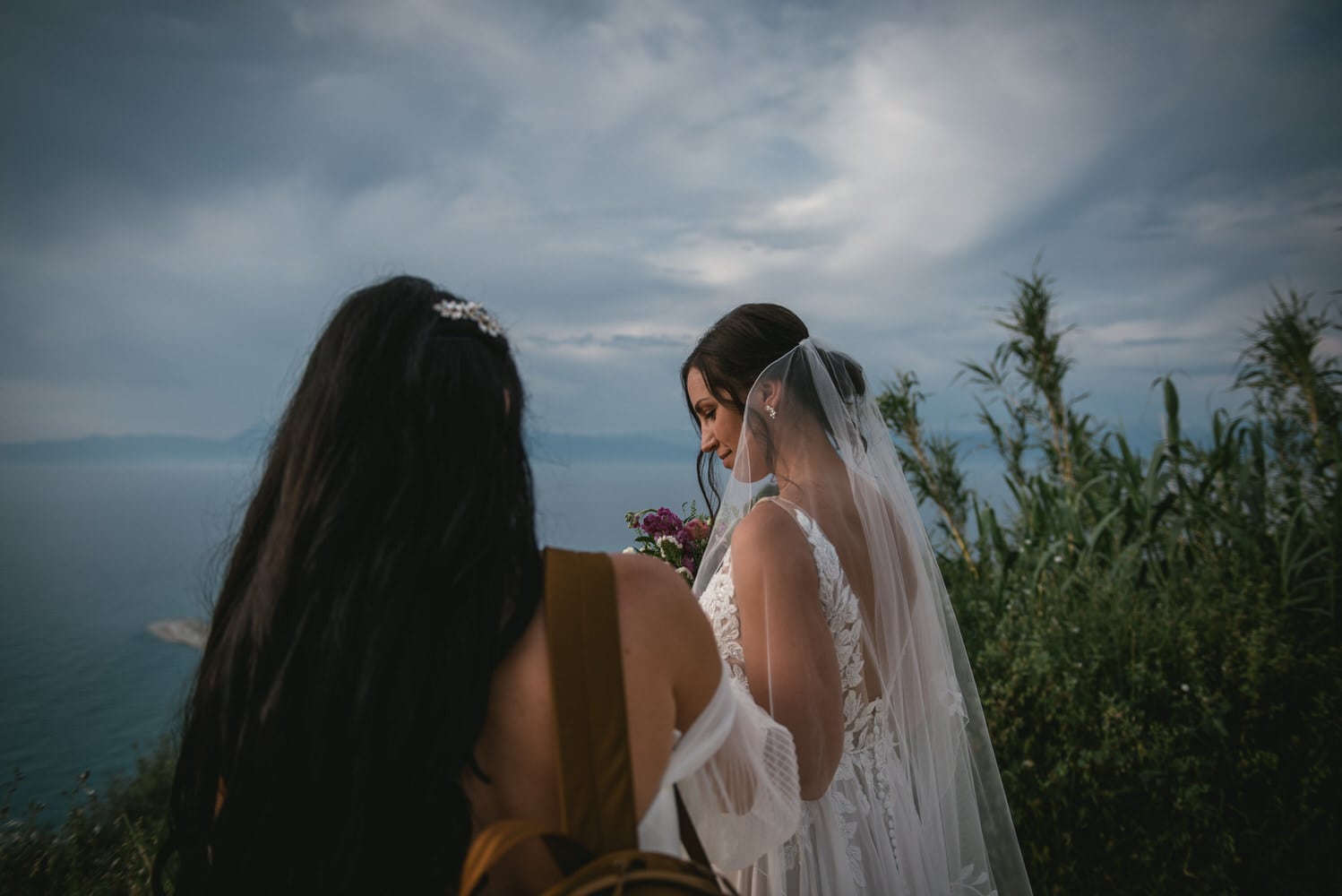 Bride's veil caught in the breeze, ethereal beauty on her Corfu elopement.