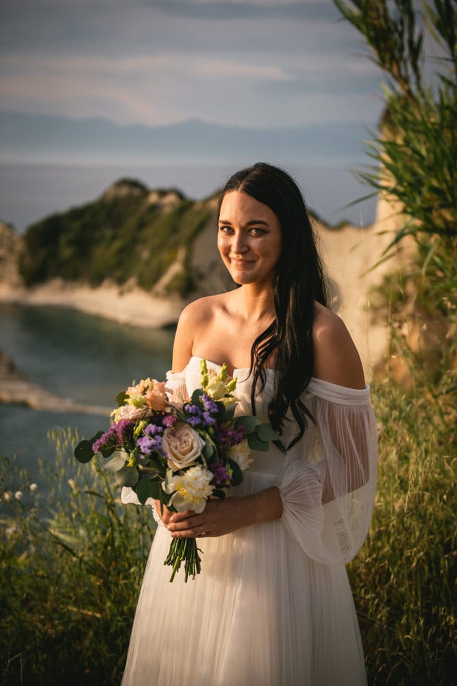 Closeup of a bride holding her bouquet, natural elegance for her Corfu elopement.