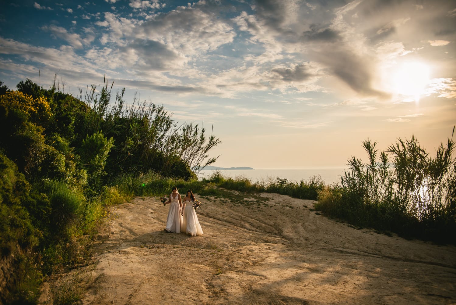 Brides walking back up towards their ceremony, anticipation in their Corfu elopement.
