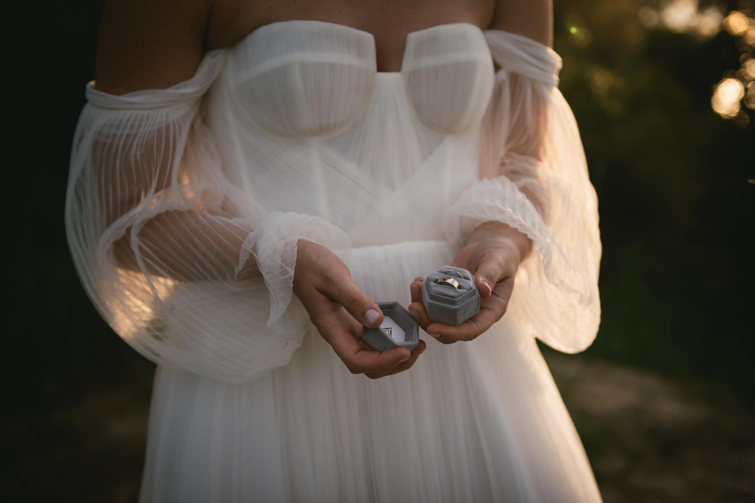 Bride's hands delicately holding the rings, a symbol of their Corfu elopement love.
