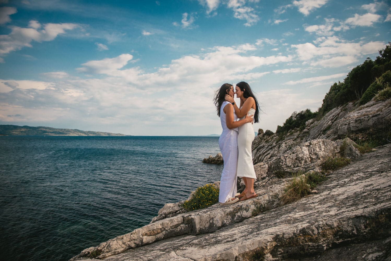 Coastal connection: Brides' footsteps along the shore, love's journey by the sea during their Corfu elopement.