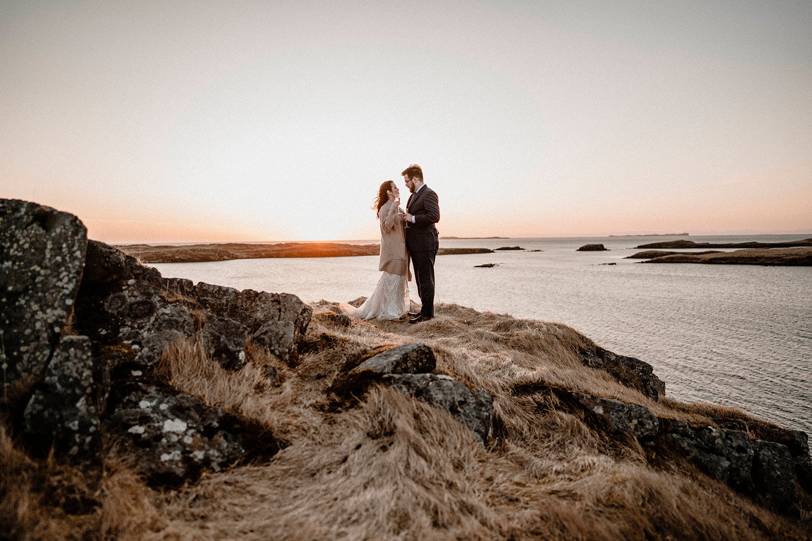 Captivating Moments: Bride and Groom Embracing by Western Iceland's Sea