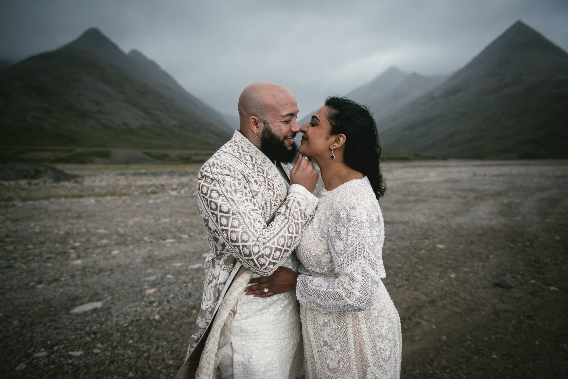 Bride and groom embrace the Icelandic winds