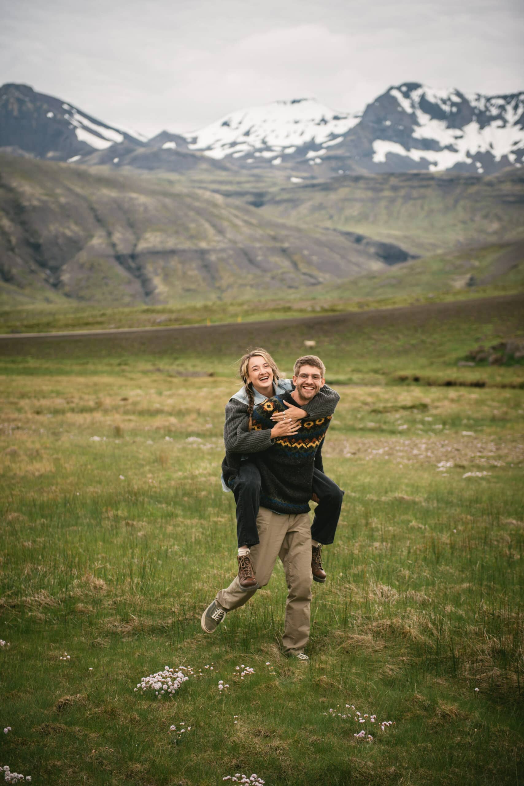 Laughing echoes against the untamed backdrop of the Westfjords, as they dance and play, letting the whims of the land inspire their love's adventure.