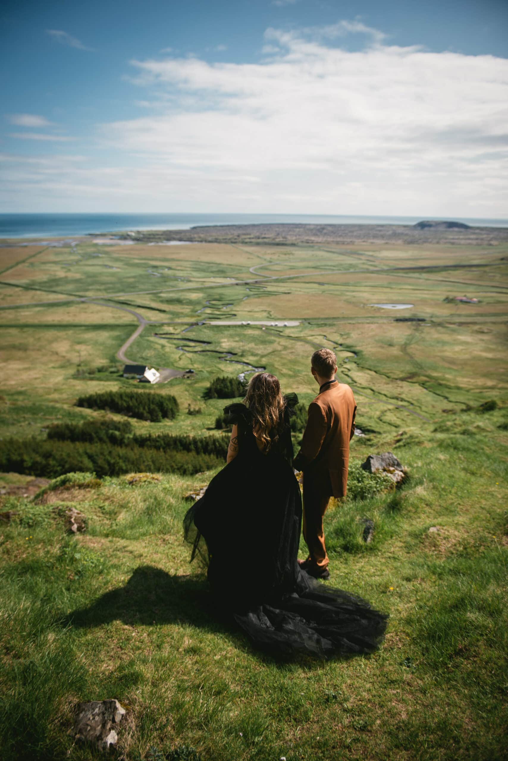 Adventurous couple explores the magical landscapes of the Westfjords hand in hand.