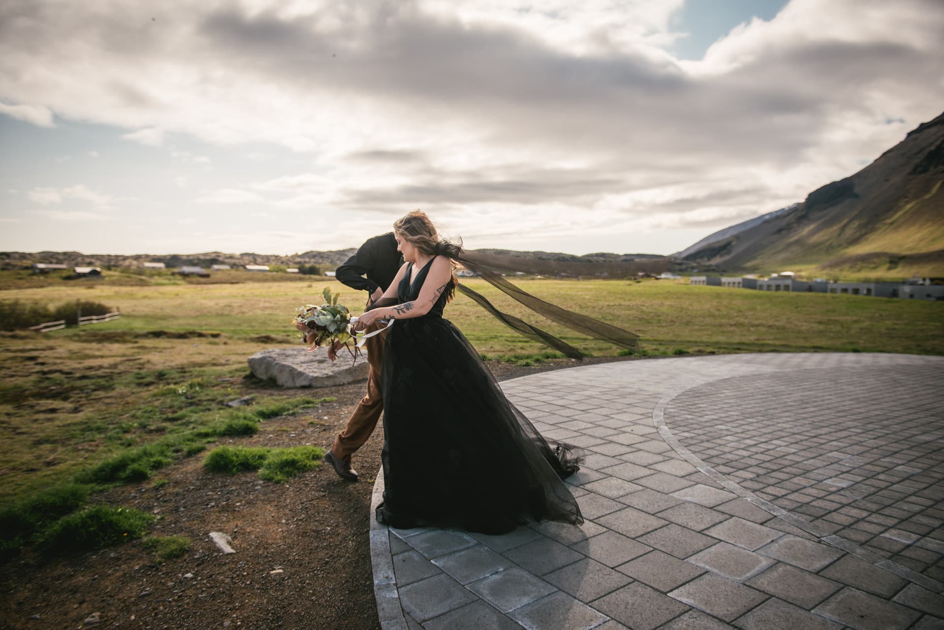 Bride's intricate lace dress stands out against the untamed landscape of the Westfjords.