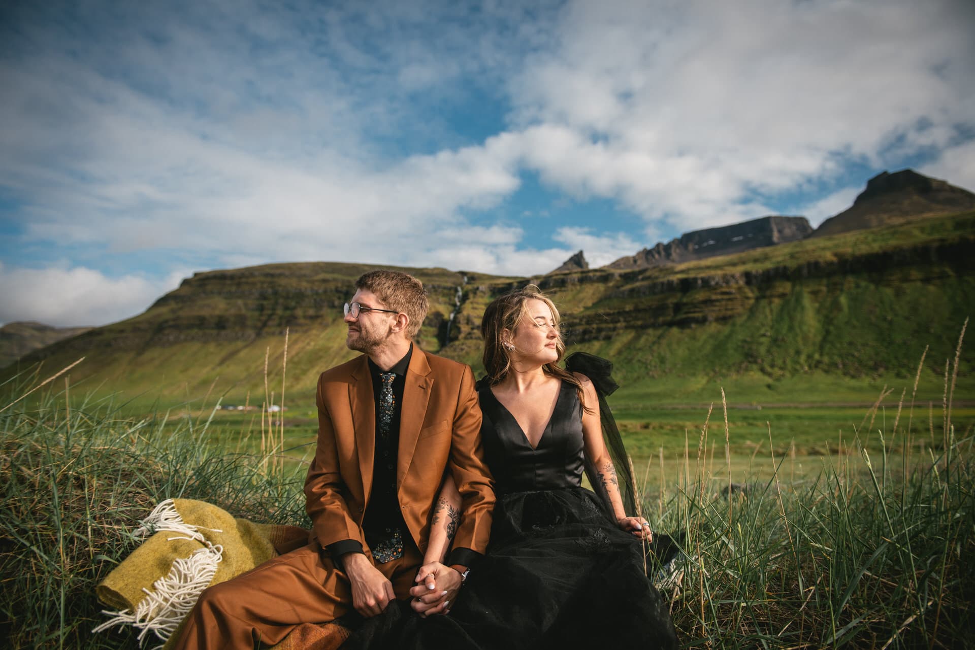 Groom's loving embrace warms the bride amidst the awe-inspiring Westfjords.