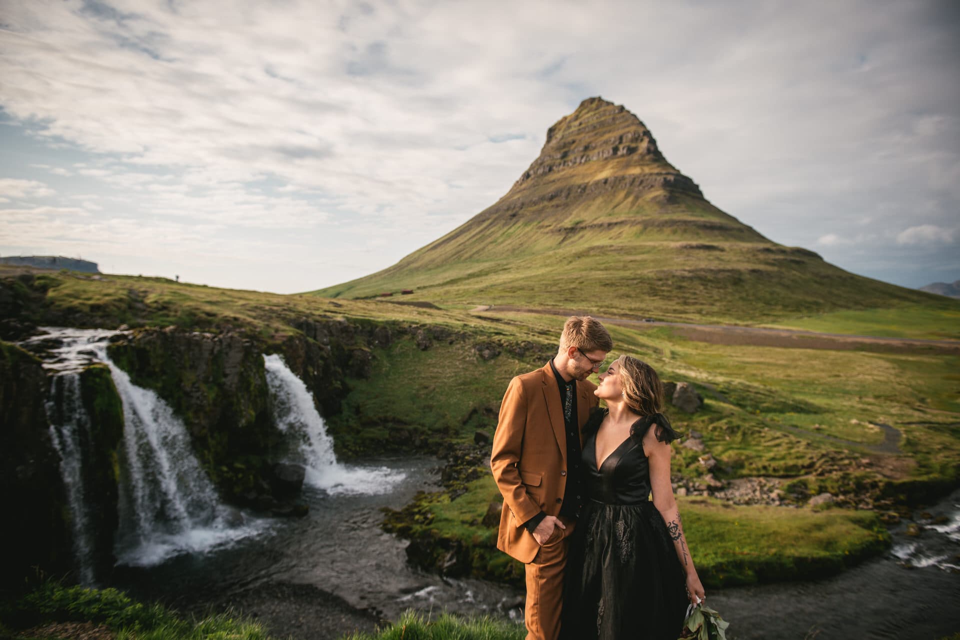 A dreamy kiss beneath the shimmering Northern Lights during their Iceland elopement.