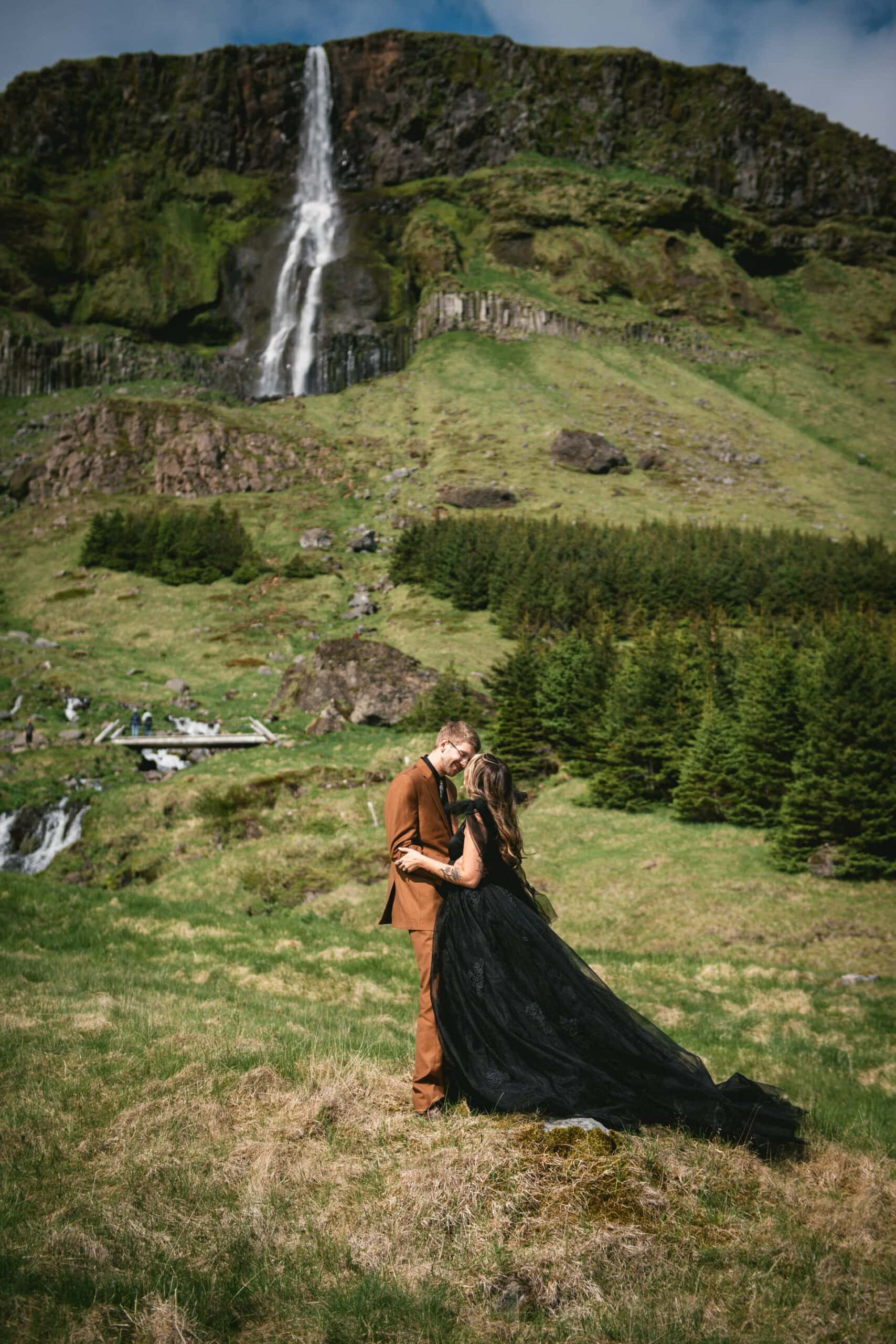 Romantic exchange of vows beside a secluded Icelandic waterfall.