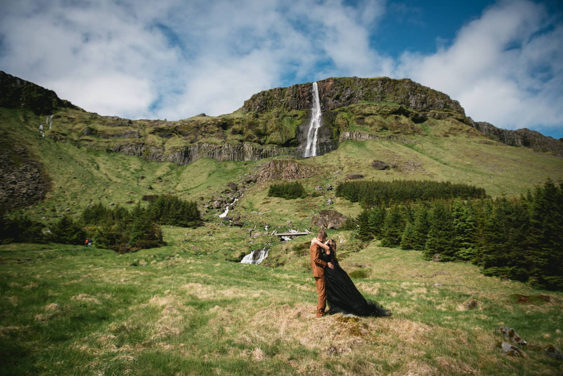 Groom's warm embrace envelops the bride in the heart of the Icelandic wilderness.