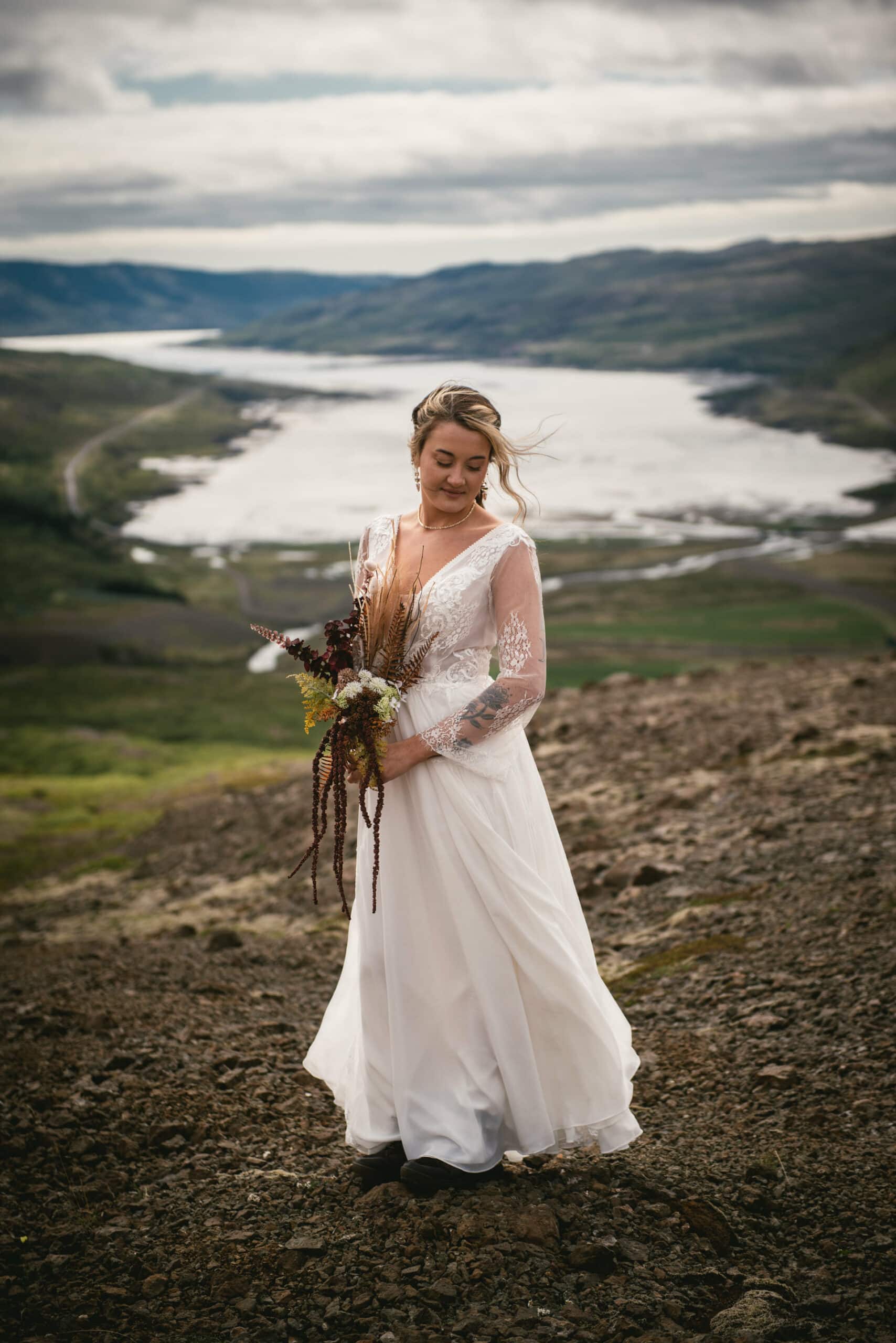 A close-up of the bride's vibrant bouquet against a backdrop of the Westfjords' dramatic landscapes.