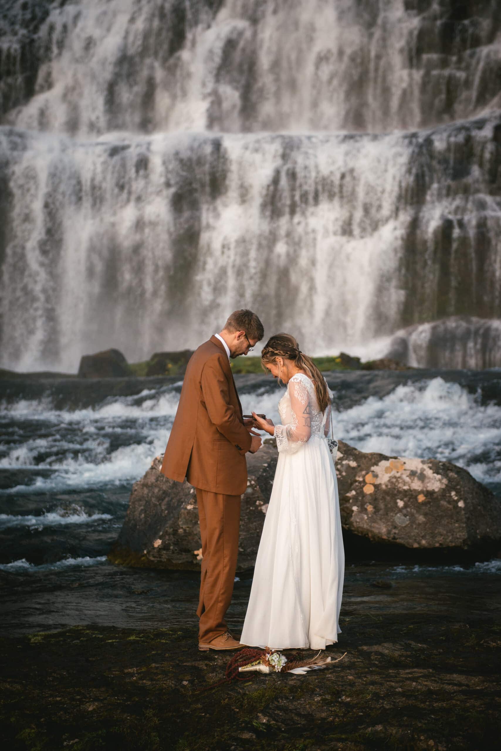 Adventure-loving couple explore a hidden waterfall during their Westfjords elopement.