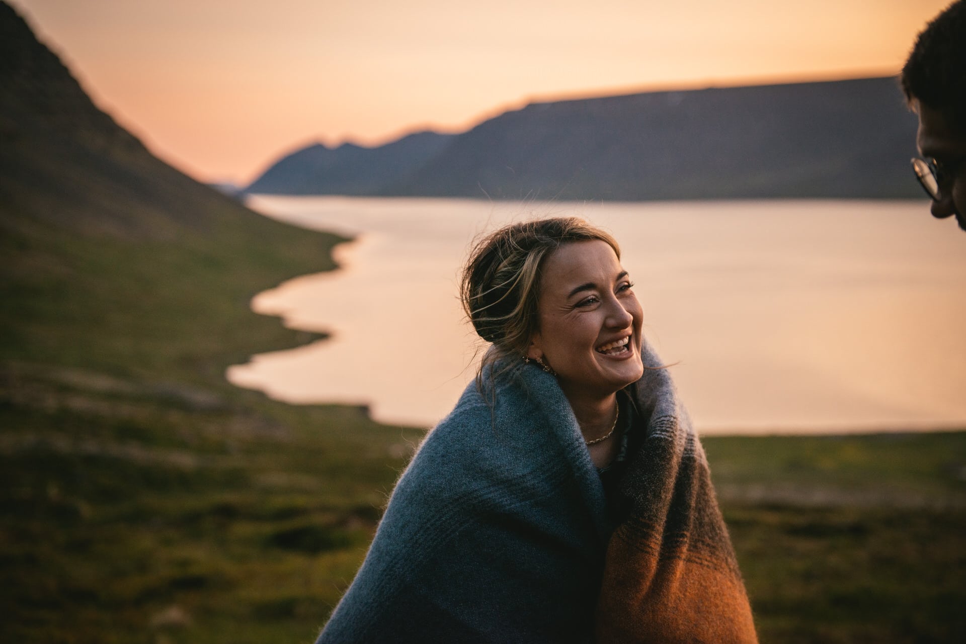 Bride's radiant smile illuminated by the soft light of the Westfjords.