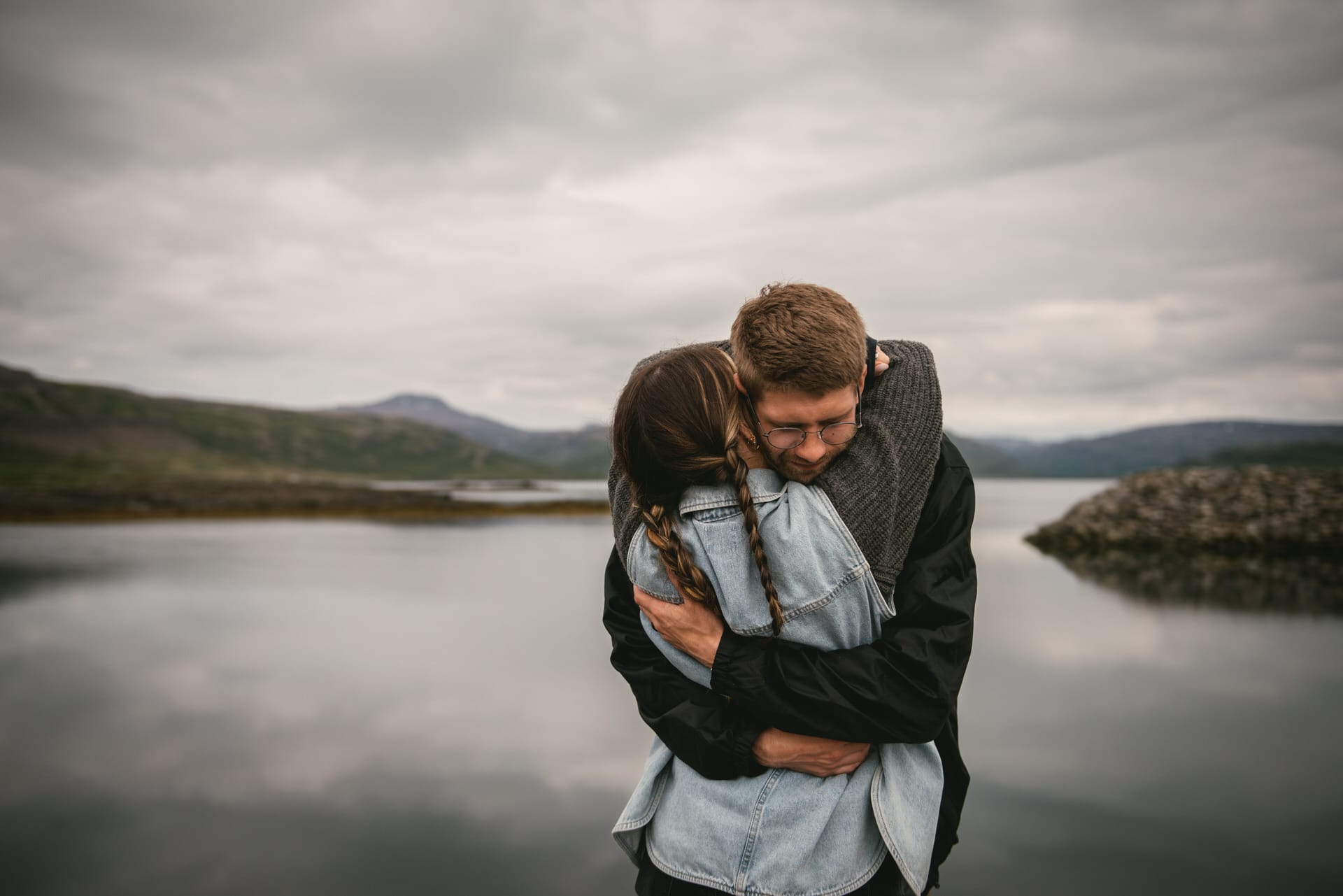 Intimate moment as the couple shares a quiet embrace amidst the captivating Westfjords.