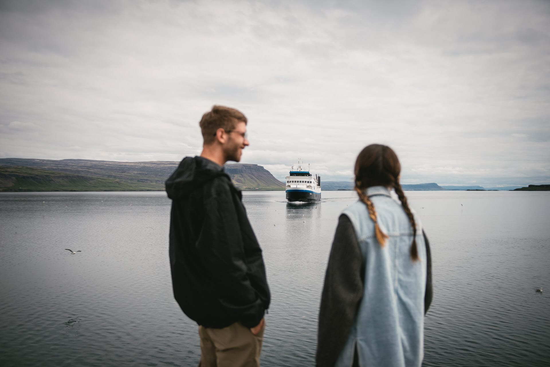 Crossing the shimmering waves, their love story rides the ferry's embrace, from Westfjords to Snaefelseness, a chapter of their adventure.