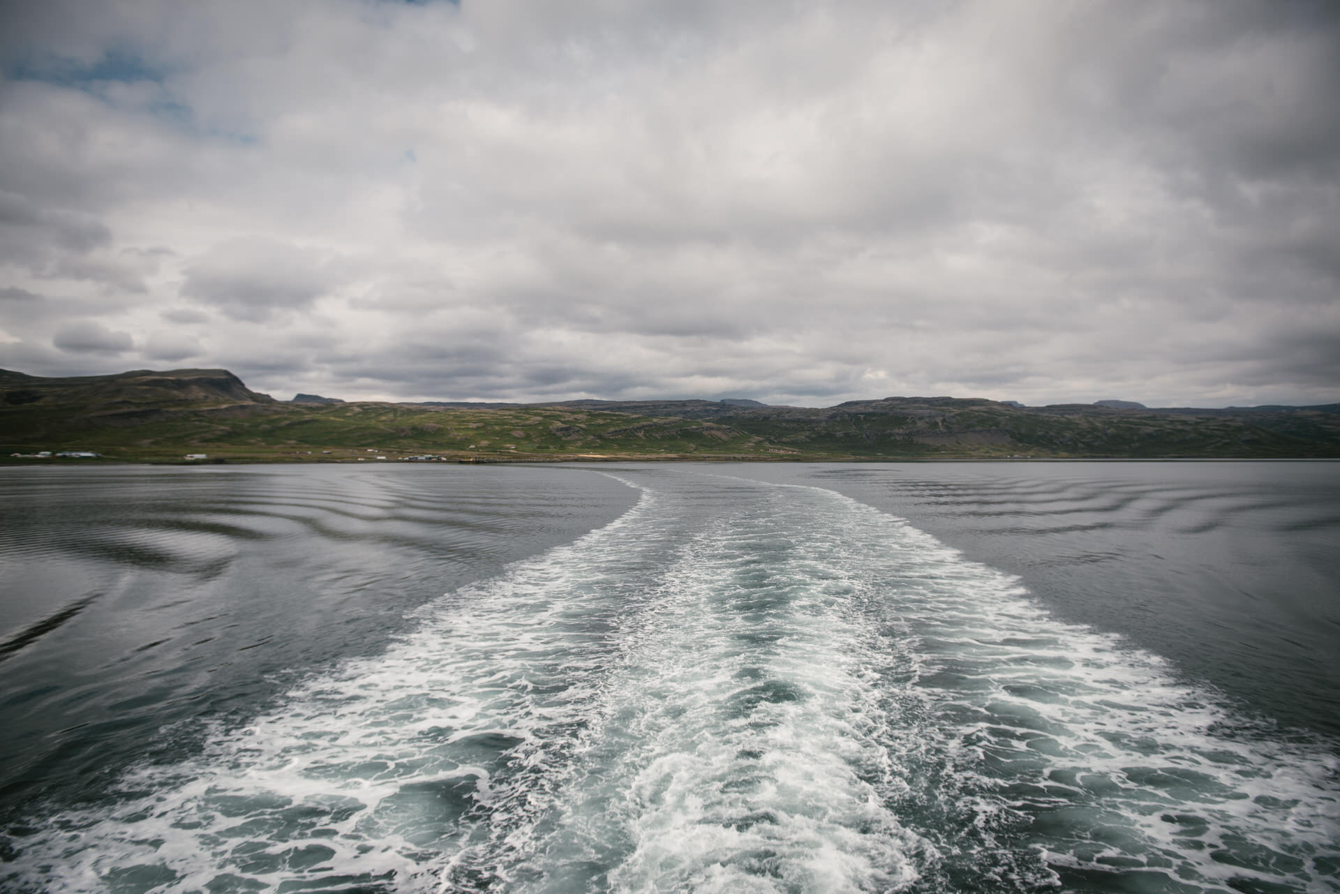 Amidst the ferry's gentle sway, their love sails from the rugged Westfjords to the awaiting embrace of Snaefelseness, a journey woven in time.