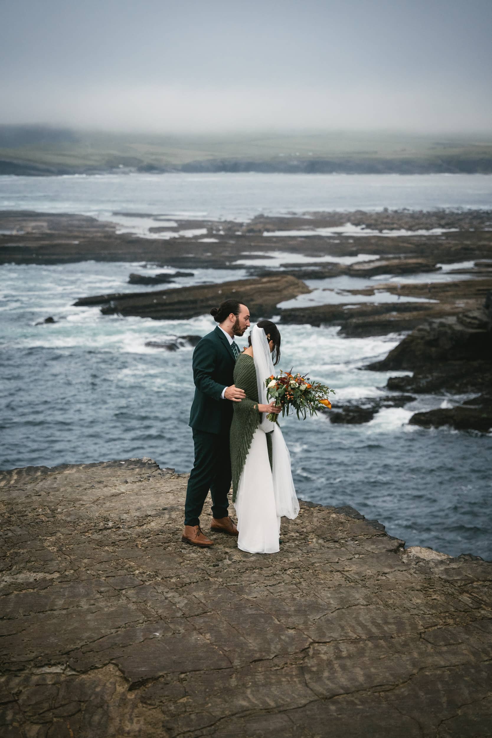 A clifftop embrace during their Irish elopement.