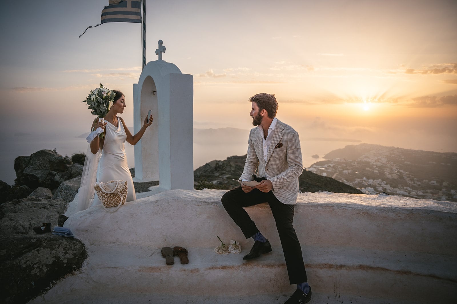 Santorini’s sky, ablaze with color, crowns their ceremony, the perfect start to forever