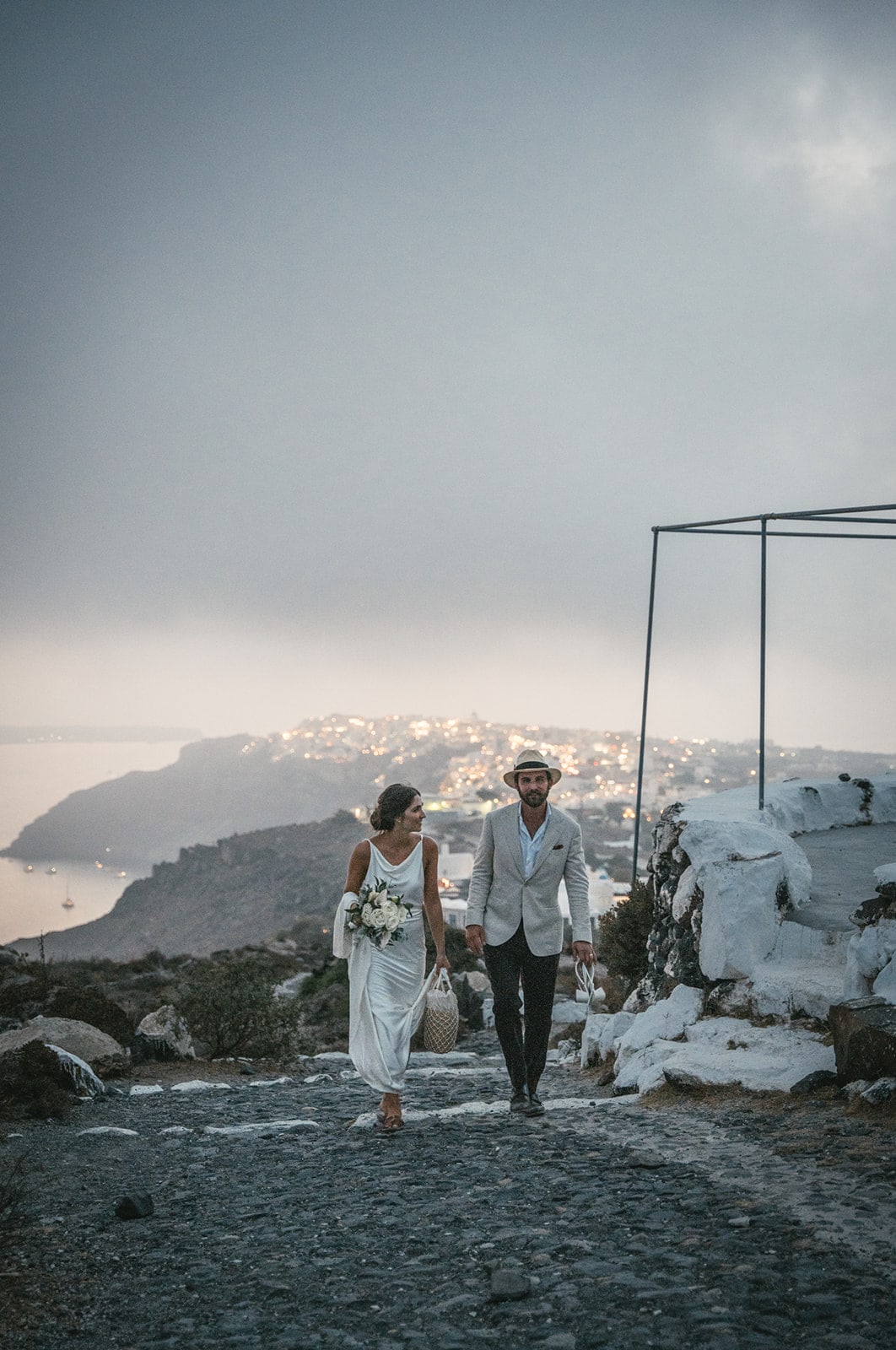 Couple walking back to the car after their sunset ceremony on Santorini