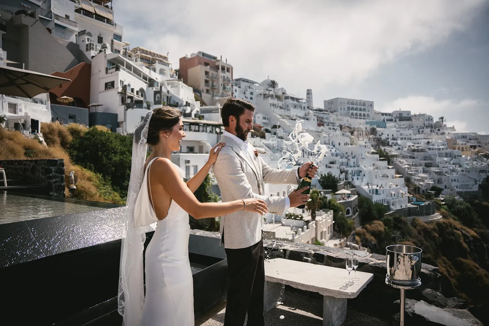 Laughter and light in their eyes, the couple's first look with Santorini’s heart beating around them