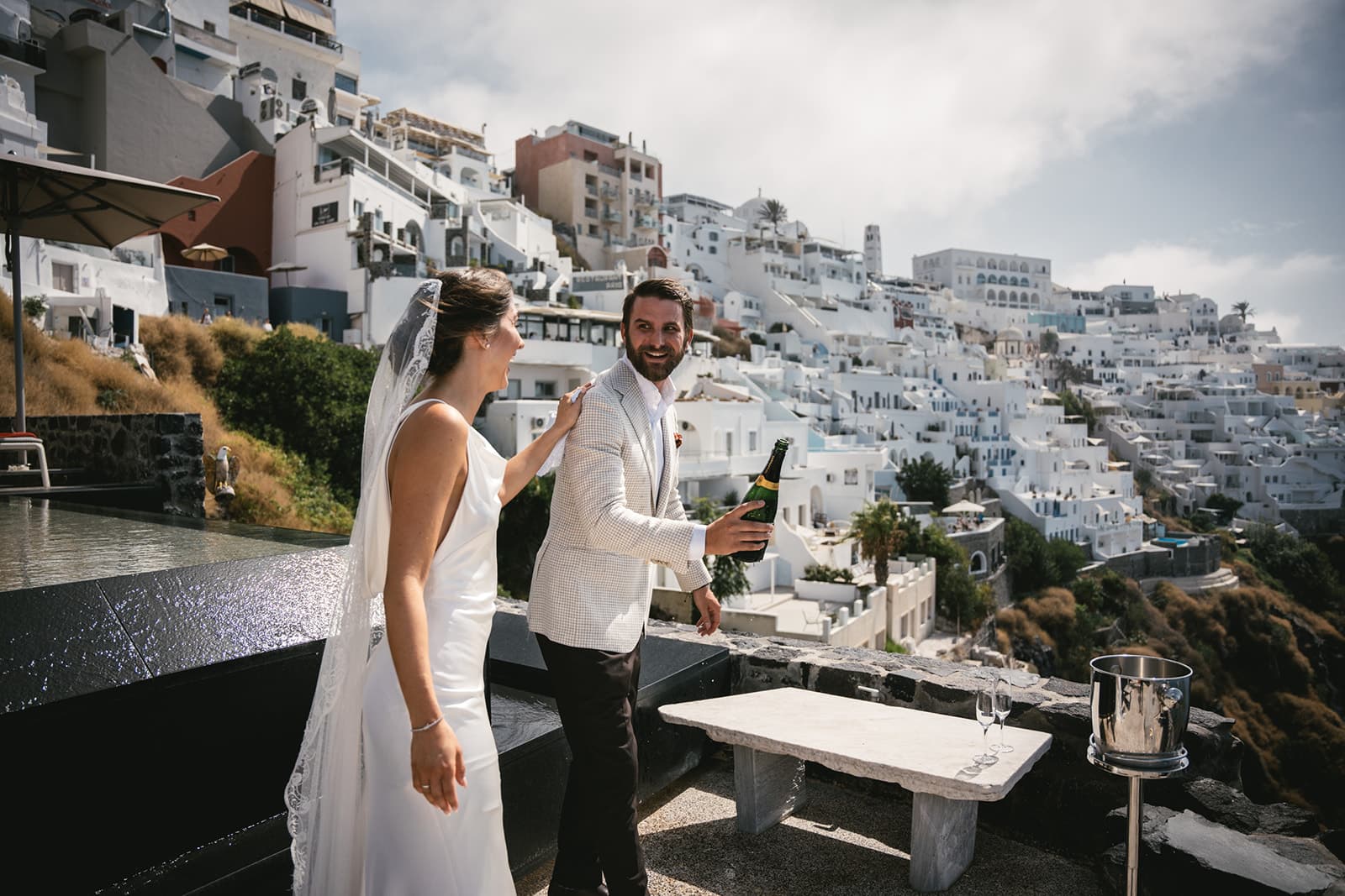 The final first look moment, anticipation giving way to joy under the Santorini sky