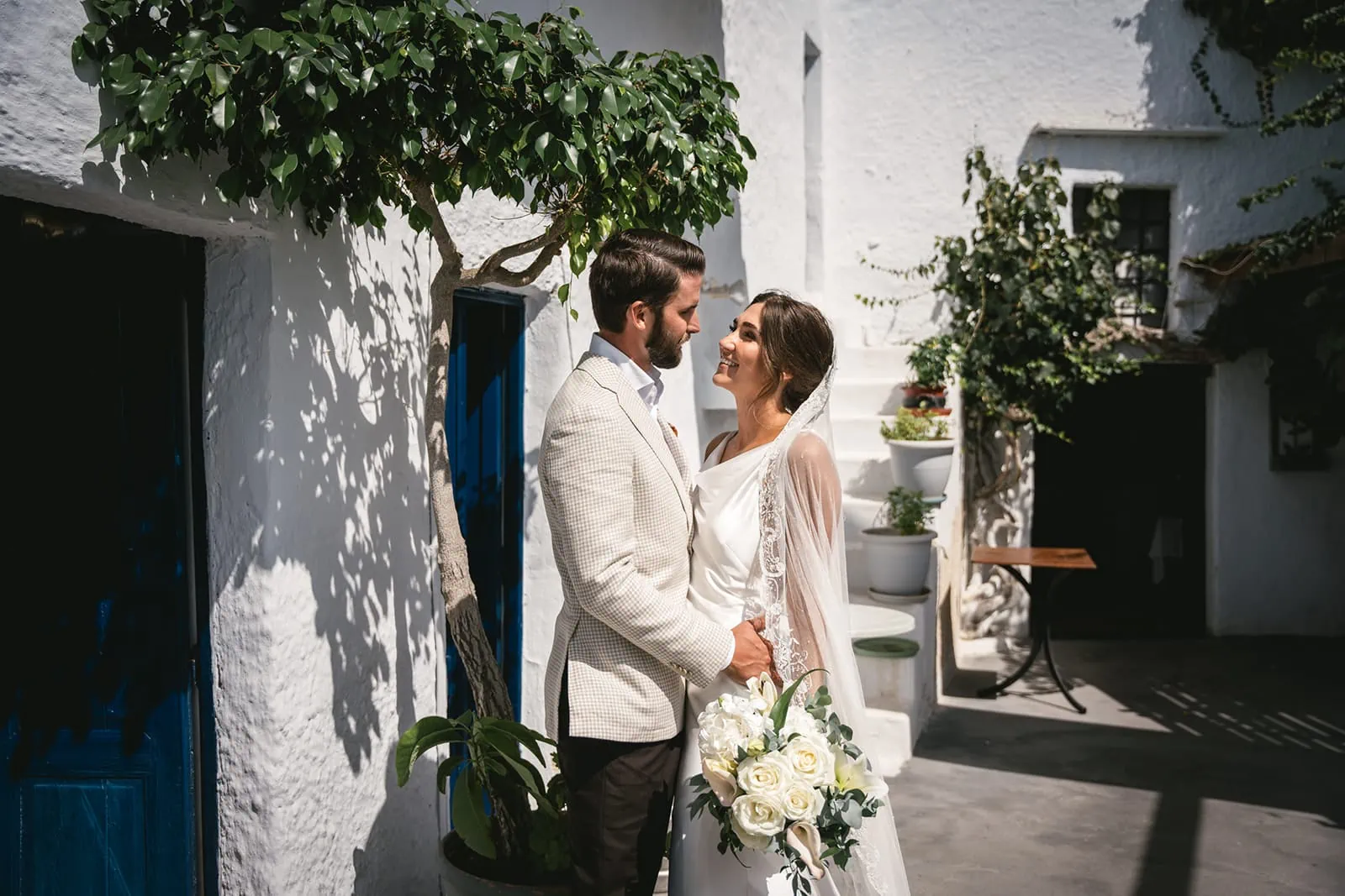 Laughter echoing through the streets of Fira, a couple in love and on the move