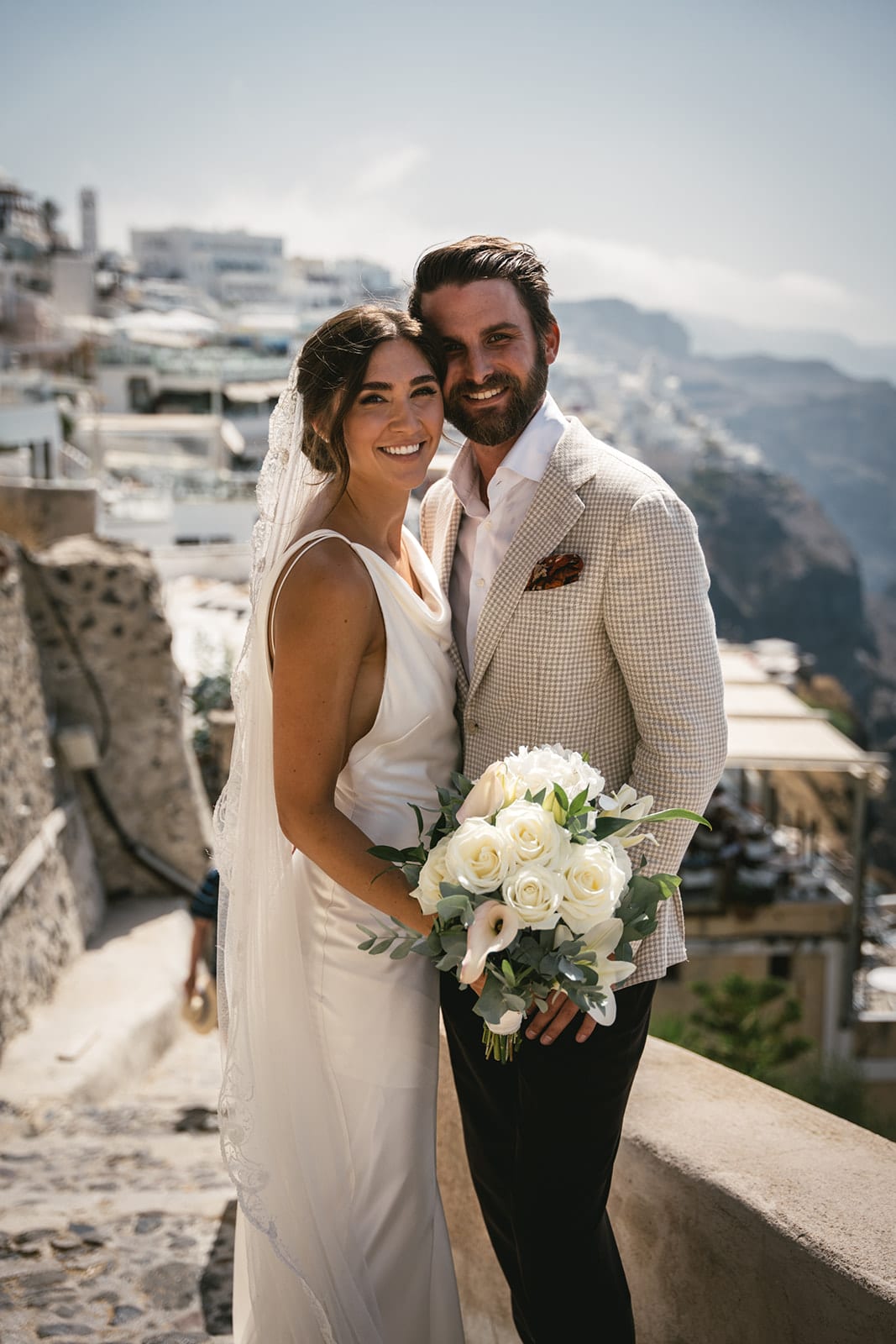 Intimate glances shared in Fira’s embrace, their love story entwined with the town