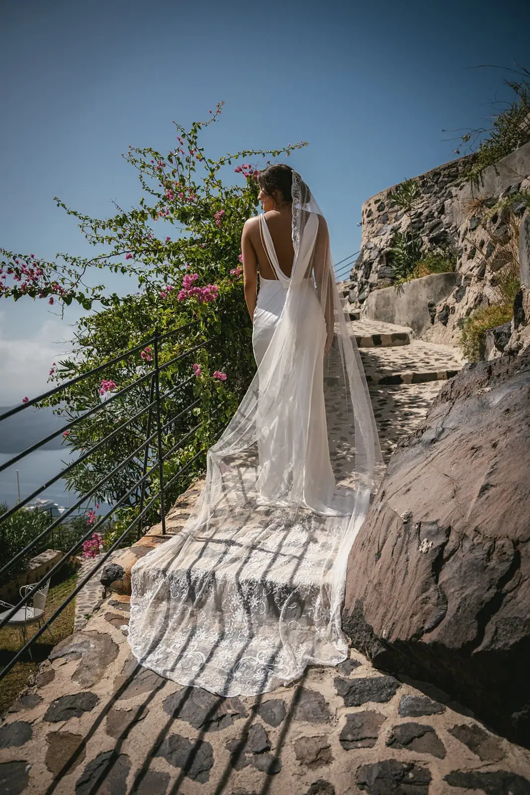 Fira’s vibrant life pulses around them, yet in each other’s gaze, they find a peaceful world