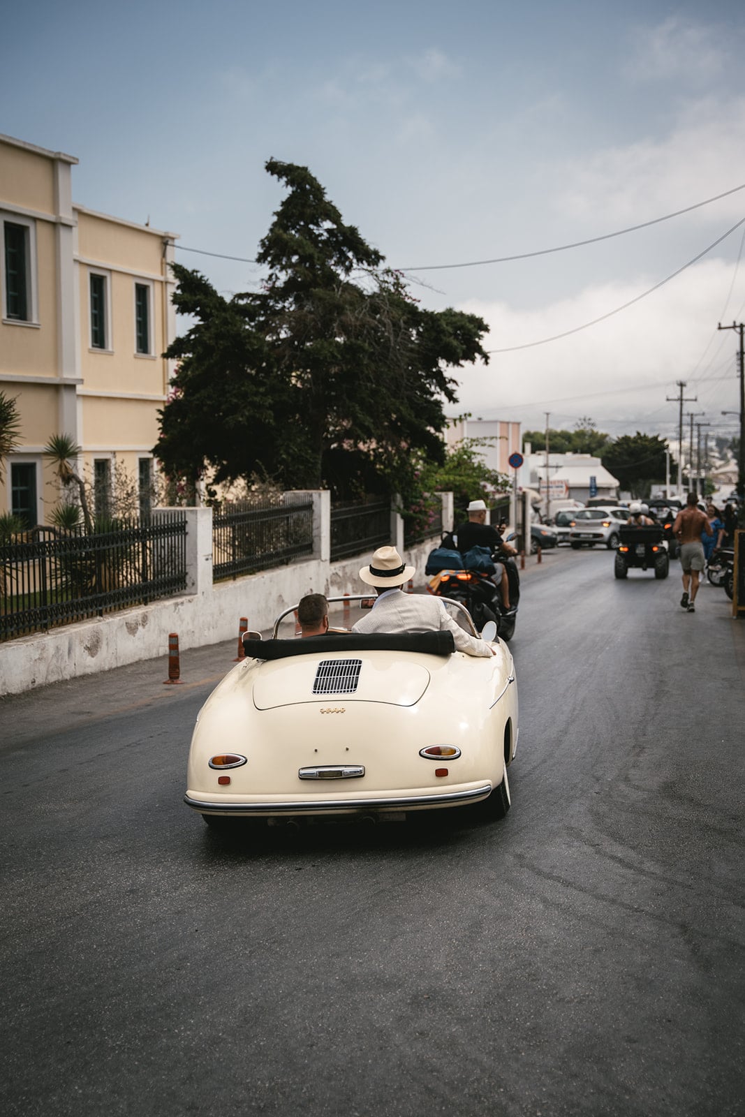 Against the sky, the couple and their vintage ride share a moment above the clouds