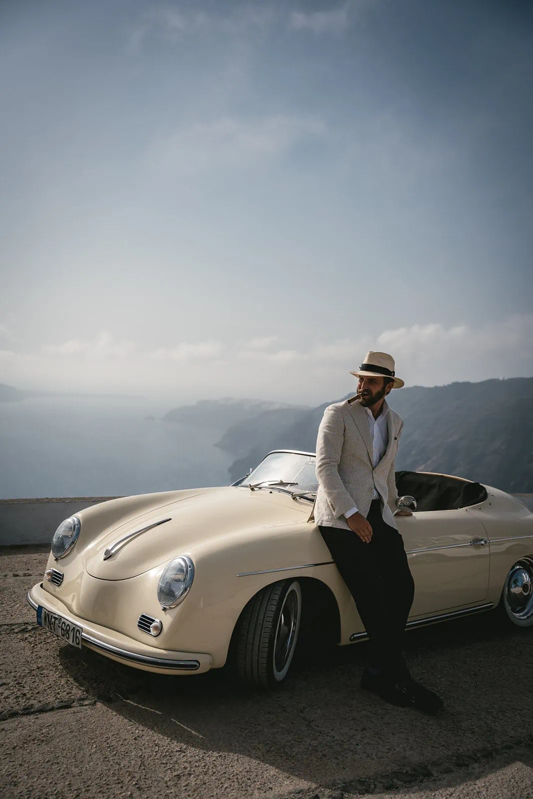 The sea whispers tales of old as the couple leans into the charm of their vintage getaway