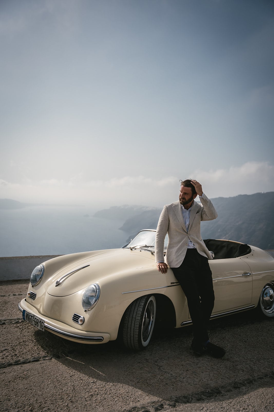 A kiss, the sea, and a vintage car - the perfect trilogy for an elopement on Santorini