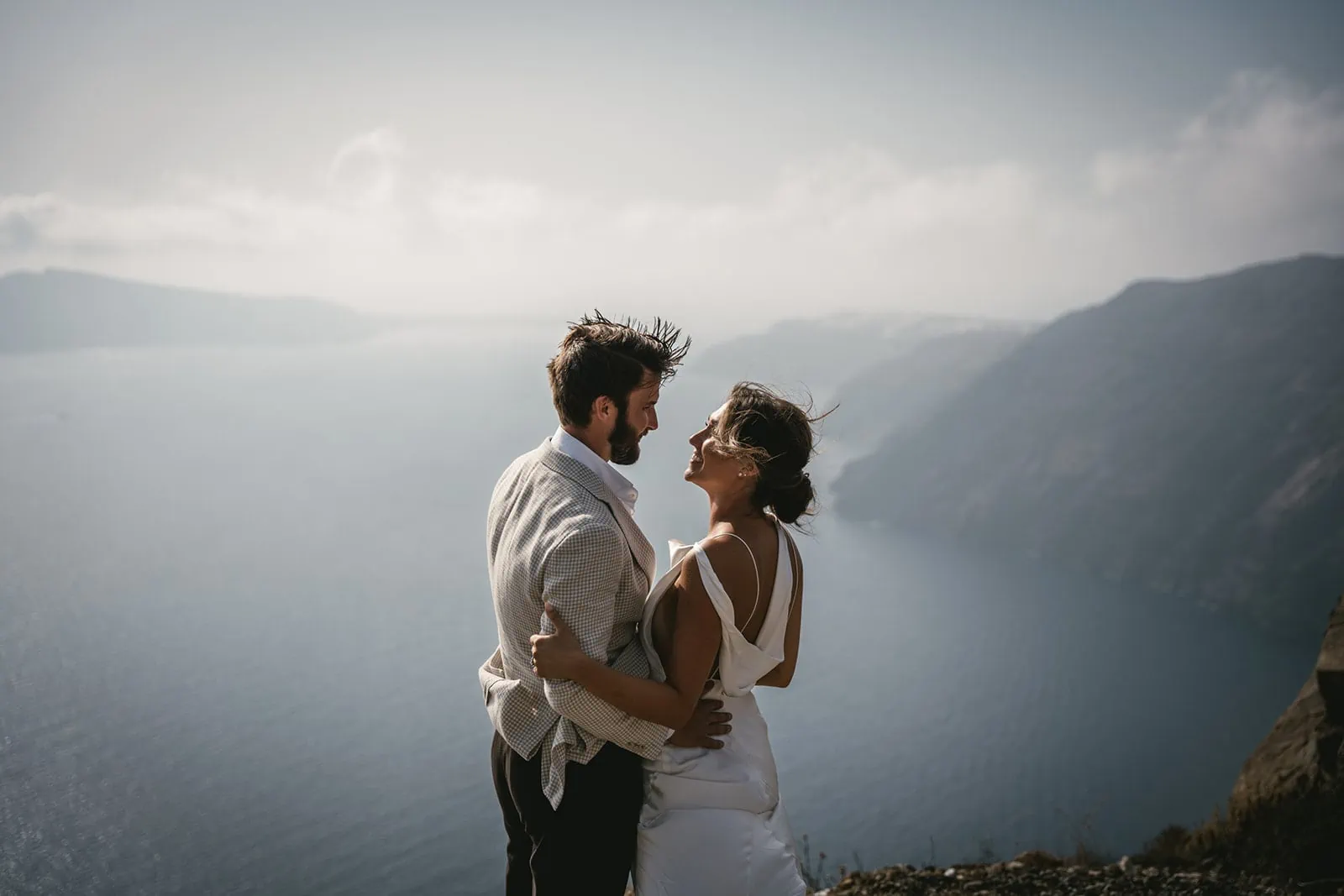Their silhouettes against the sea, dancing, kissing, a perfect moment of elopement bliss