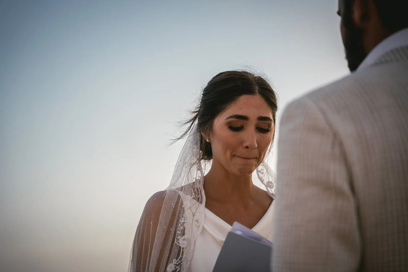 Santorini's sunset paints their ceremony in hues of love, a masterpiece of moments