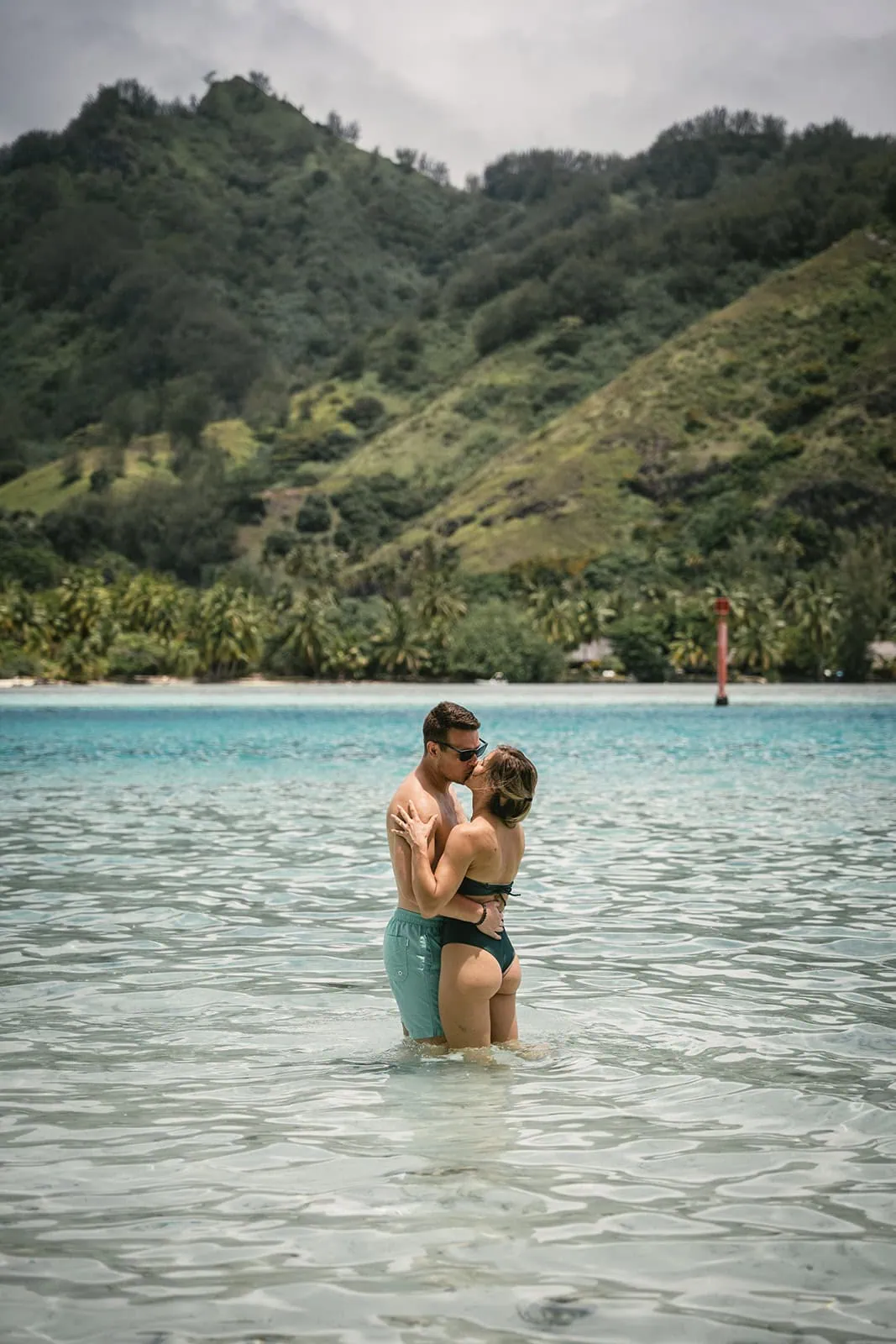 French Polynesia elopement with bride and groom exchanging kiss on a pristine beach