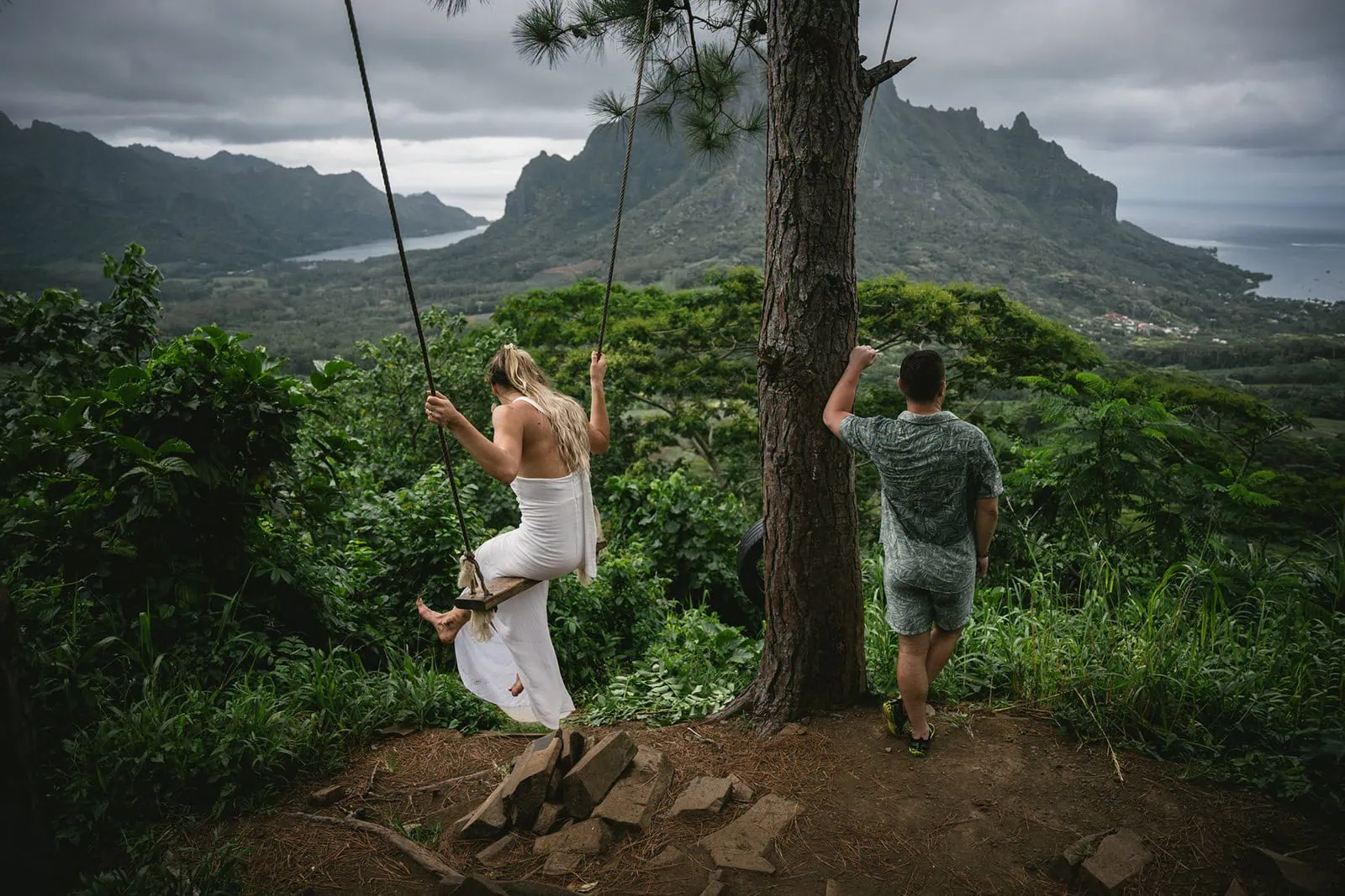 Bride and groom enjoying a swing in the lush Polynesian forest