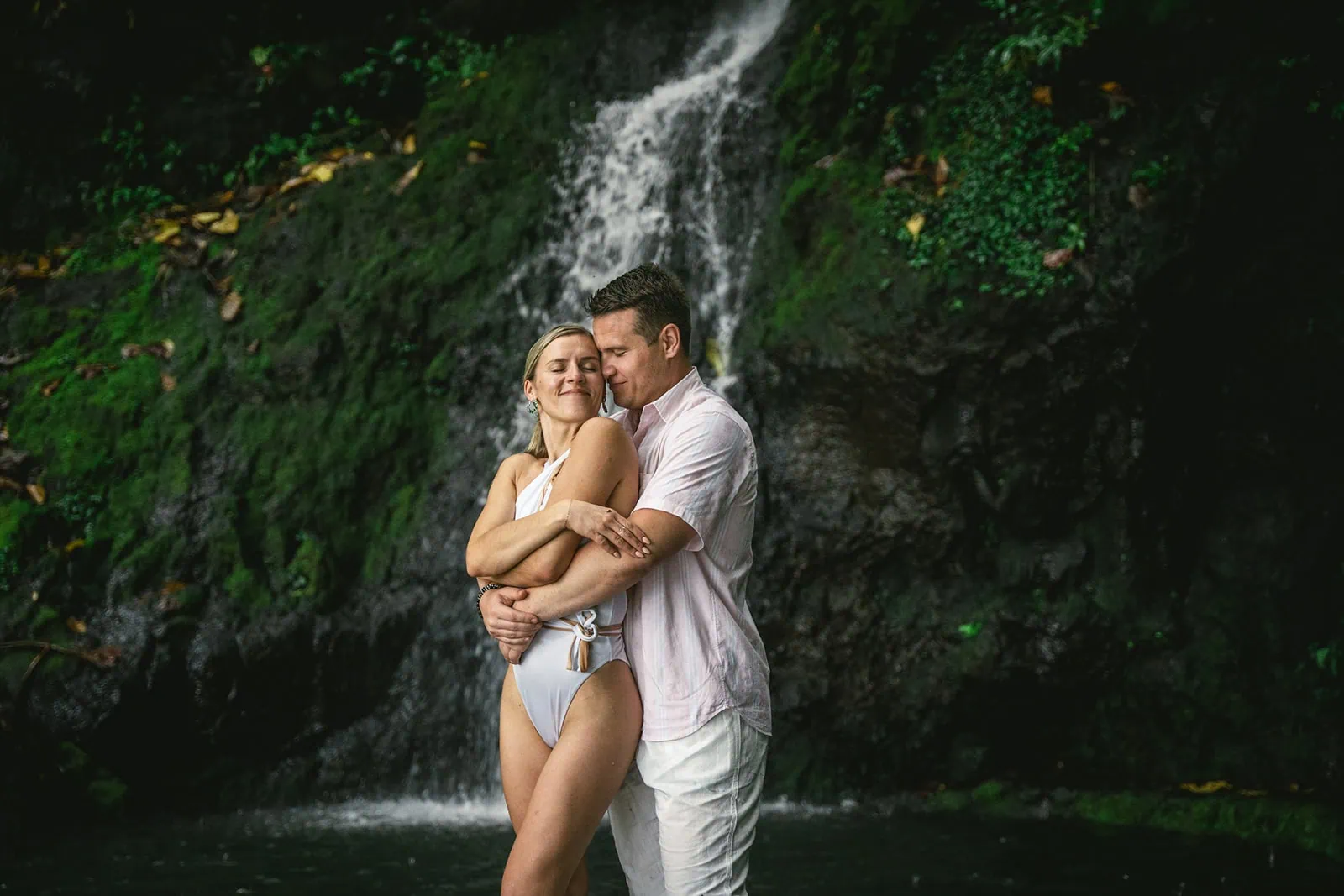 Bride and groom exchanging at a secluded waterfall in French Polynesia